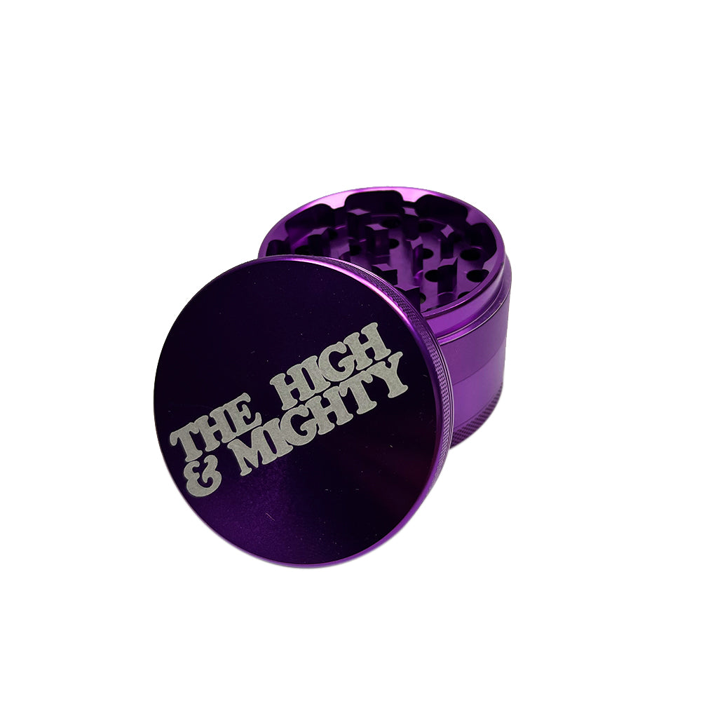 purple metal grinder with white the high & mighty on top