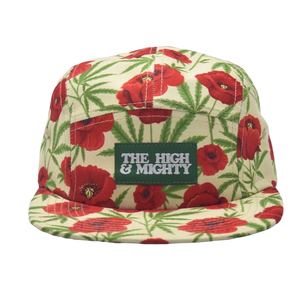 cream hat with red poppies and green marijuana leaqves on it. Front has green label that reads the high & mighty